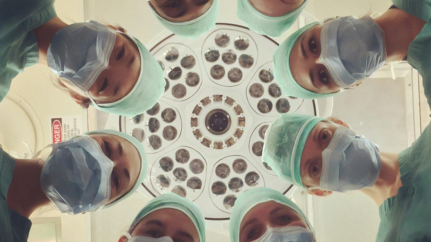 Surgical team in an operating theatre, representing hospital cover under health insurance